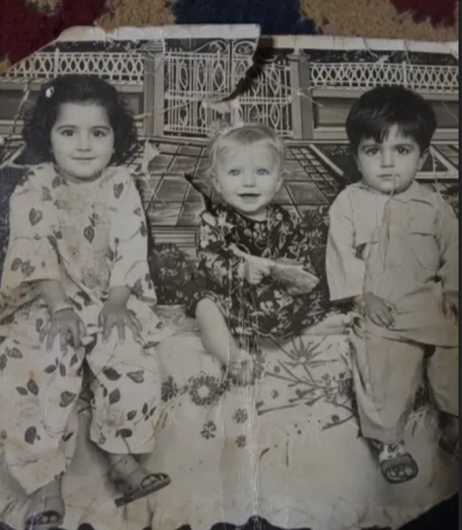 Restore an old damaged photo to high quality. Repair scratches, tears, and faded areas while keeping the faces and details natural.
